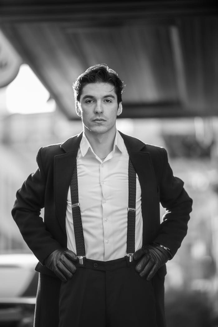 Elegant man in a suit with suspenders in black and white, Baku street scene.